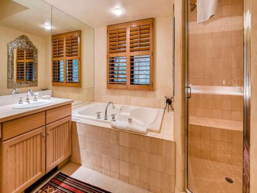 a bathroom with a tub and a sink and a shower at Beaver Creek Pines 3 Bedroom Ski In, Ski Out Vacation Rental With Restaurant, Outdoor Pool, Jacuzzi And Fitness Center in Beaver Creek