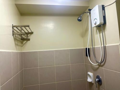 a shower in a bathroom with a shower head at Avida Aspira Condotel in Cagayan de Oro