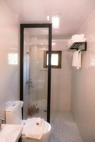 a bathroom with a shower and a toilet and a sink at Patio by Balai Norte in San Juan
