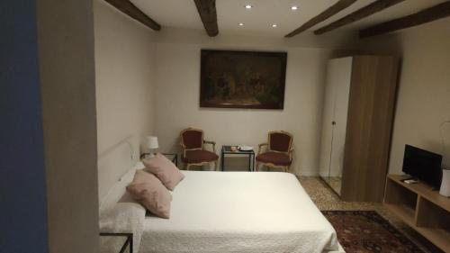 a bedroom with a white bed and a tv at Residence Castello Venezia in Venice