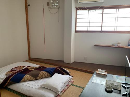 Postel nebo postele na pokoji v ubytování 民宿ニュー万福茶屋