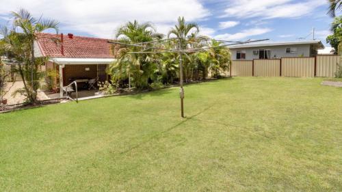 a small tree in the yard of a house at Comfortable lowset family home only minutes from the water! Tarooki St, Bellara in Bellara