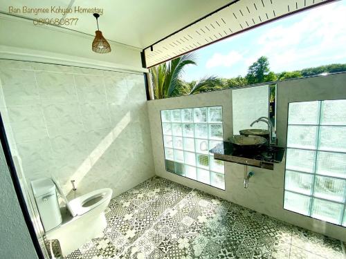 a bathroom with a toilet and a sink and a window at Bang Mee Homestay Koh Yao Noi in Ko Yao Noi