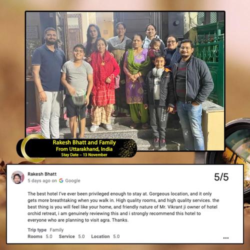 a picture of a family posing for a picture on a website at The Orchid Retreat in Agra