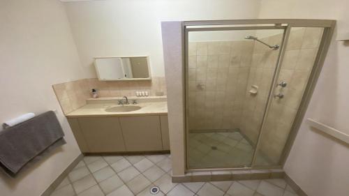 a bathroom with a shower and a sink at Puggle Palace, 21A Bower Street in Jurien Bay