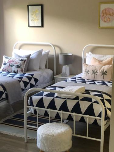 two beds sitting next to each other in a room at Sea Change Guesthouse in Apollo Bay