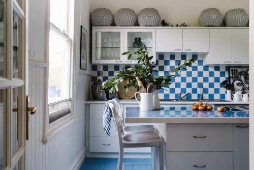 a kitchen with blue and white tiles and a counter at Carrington House Daylesford in Daylesford