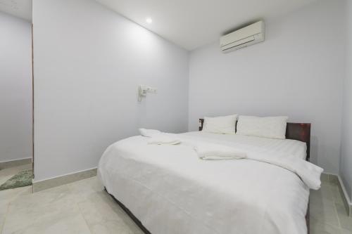 Ένα ή περισσότερα κρεβάτια σε δωμάτιο στο Residence 110 (Hotel and Apartments)