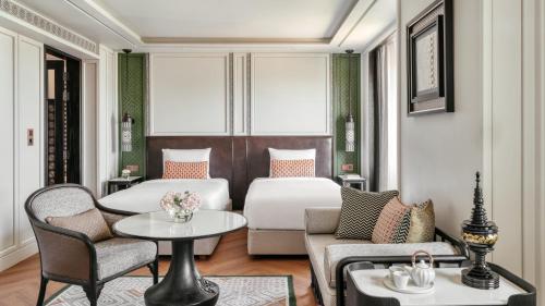 a hotel room with a bed and a couch and a table at InterContinental Chiang Mai The Mae Ping in Chiang Mai