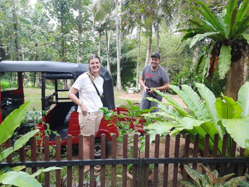 a woman standing in front of a small train at Nature's Hideout Holiday Home in Mirigama