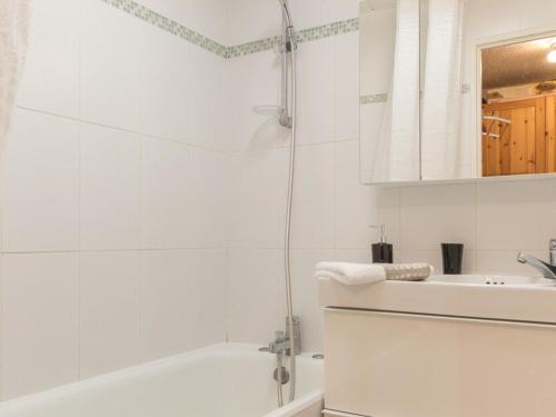 a white bathroom with a shower and a sink at Appartement Saint-Chaffrey , 4 pièces, 6 personnes - FR-1-330E-17 in Serre Chevalier