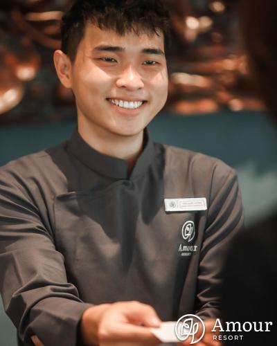 a man is smiling with his arms crossed at Amour Resort Bavi in Hanoi