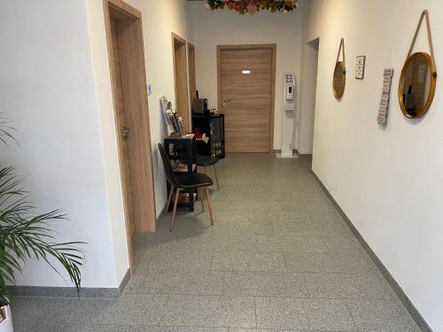 a hallway with chairs and a table in a room at Die 1A Pension in Welsau