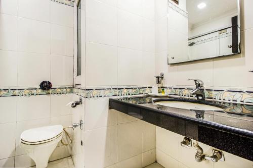 a bathroom with a toilet and a sink at FabHotel Aaykay Model Town in Amritsar