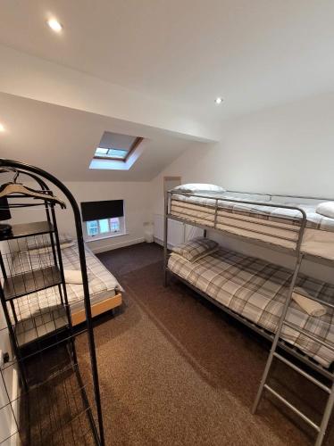 a room with two bunk beds and a skylight at 3 Laurel Court in Ulverston