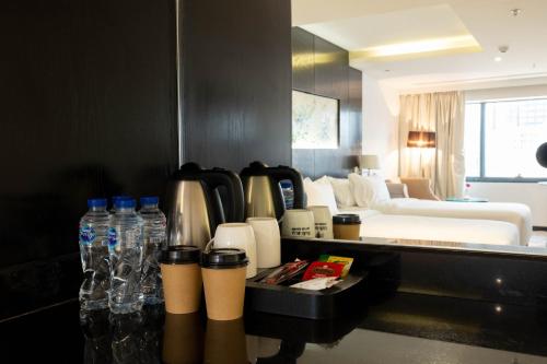 a hotel room with bottles of water and a couch at Mira Business Hotel in Riyadh