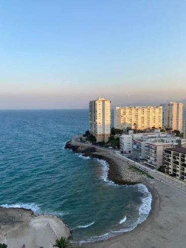 an aerial view of a beach with buildings and the ocean at Precioso apartamento en el Faro de Cullera in Cullera