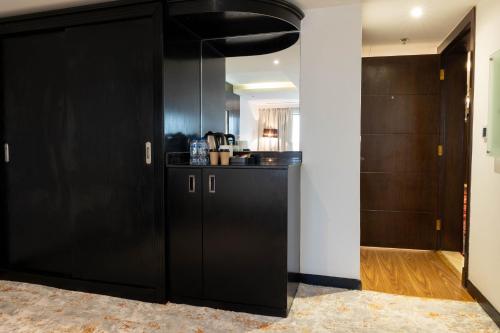 a large black closet in a room with wooden doors at Mira Business Hotel in Riyadh