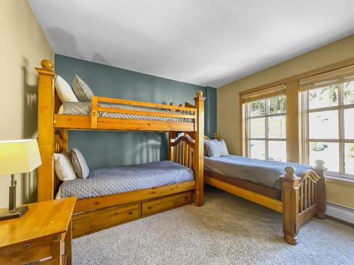 two bunk beds in a room with a desk at PP403 Passage Point condo in Copper Mountain