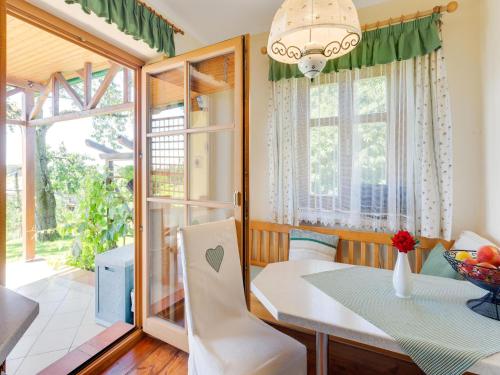 a dining room with a table and a window at Holiday home in Gersdorf near a swimming lake in Gersdorf an der Feistritz