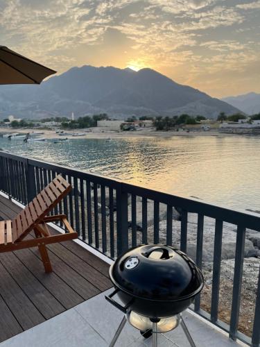 a black helmet sitting on a deck next to the water at Iconic 4-bedroom villa with pool in Fujairah Palm in Fujairah