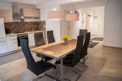 a kitchen and dining room with a wooden table and chairs at Villa Nordhang in Winterberg