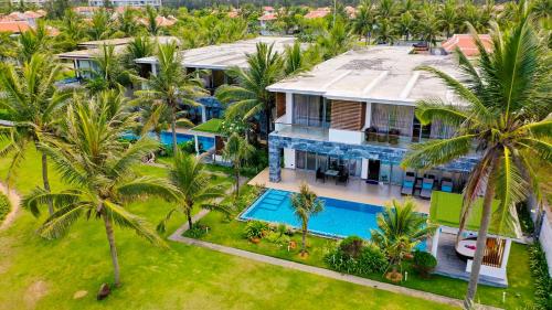 an aerial view of a house with a swimming pool at The Ocean Villa Resort Beachfront By Abogo in Da Nang
