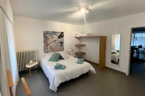 a small bedroom with a bed and a mirror at Apartment with free covered parking - City Center in Ghent