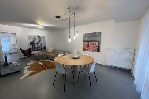 a living room with a table and a couch at Apartment with free covered parking - City Center in Ghent