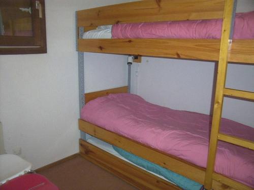 Un dormitorio con dos literas con sábanas moradas. en Studio Cabine À Risoul 1850 - 4 Couchages, Ski, Animaux Acceptés, Proche Commerces et Navette - FR-1-330-182, en Risoul
