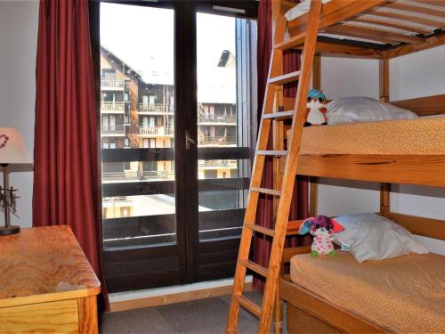 - une chambre avec des lits superposés et une grande fenêtre dans l'établissement Appartement Confortable avec Piscine, Tennis et Animaux Acceptés à Risoul - FR-1-330-143, à Risoul