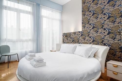 a bedroom with a white bed with towels on it at Italianway - Cannobio 8 in Milan