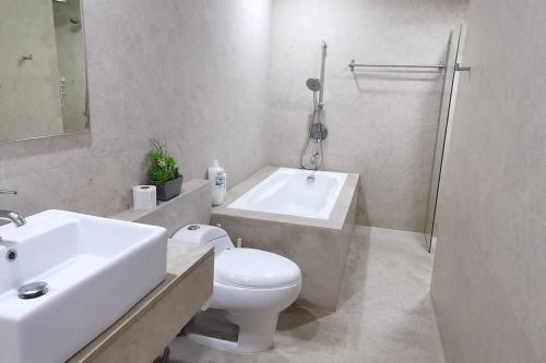 a bathroom with a sink and a toilet and a bath tub at Avengers Crib 3BR Near KLCC in Kuala Lumpur