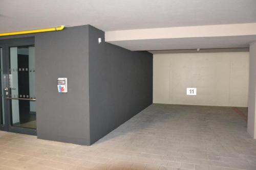 an empty room with a gray wall and a door at Residence Vlčice in Pec pod Sněžkou