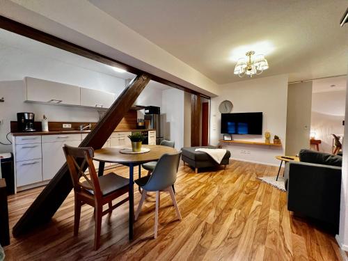 Il comprend une cuisine et un salon avec une table et des chaises. dans l'établissement Modernes Apartment mit besonderem Charme - 1A Guesthouse, 