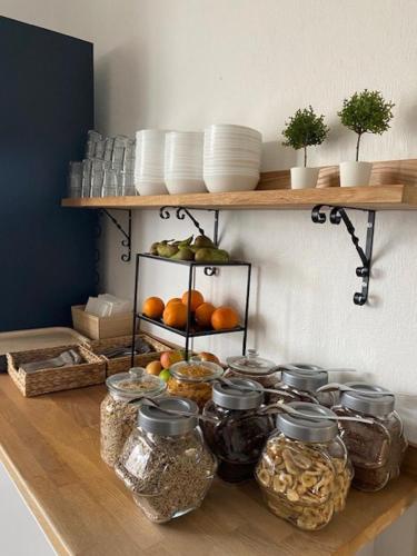 a shelf filled with jars of food on a counter at Adels Hotel in Oskarshamn