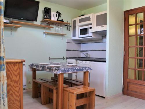 une cuisine avec une table et un comptoir dans l'établissement Appartement 4 pers, proche pistes, piscine, Risoul 1850 - FR-1-330-39, à Risoul