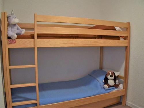 a wooden bunk bed with a stuffed dog sitting on it at Studio coin montagne calme, 4 pers, parking, Risoul 1850 - FR-1-330-92 in Risoul