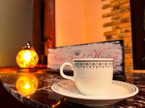 a coffee cup on a plate on a table at Villa Monrepos in Myoko