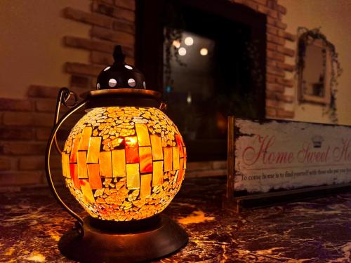 a glass vase sitting on a table in front of a fireplace at Villa Monrepos in Myoko
