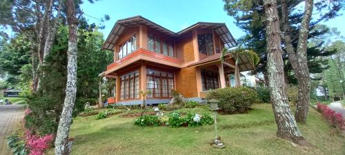 a wooden house in the middle of some trees at Villa Dinar Tulip VIB in Lembang