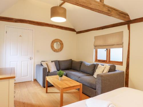 a living room with a couch and a table at Little Batts in Edenbridge
