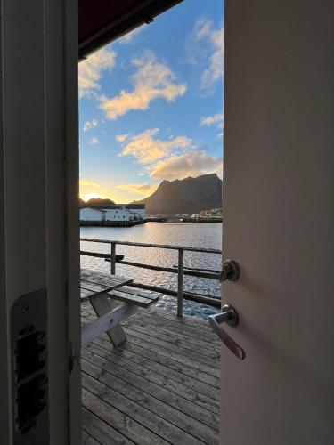 a door open to a dock with a view of the water at Toppøy Rorbuer in Reine