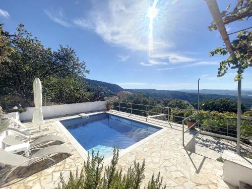 a swimming pool with a view of the mountains at Villa Corfou in Corfu Town