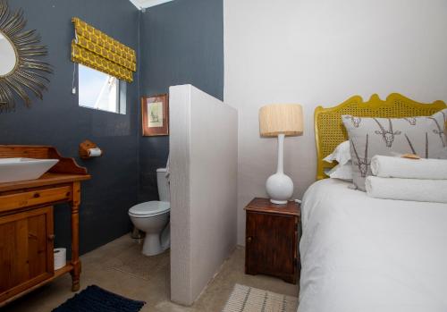 a bedroom with a bed and a sink and a toilet at Springvale Farm in Nottingham Road