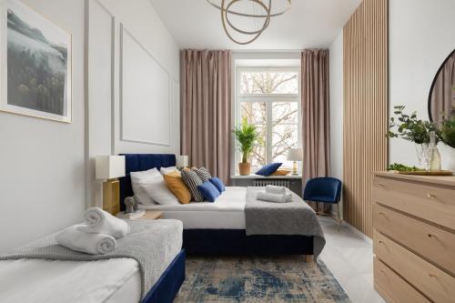a hotel room with two beds and a window at Movo Old Town Apartments in Warsaw