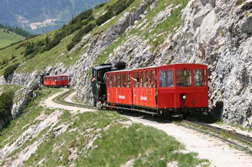 two red trains on tracks on a mountain at Hotel Zimmerbräu in St. Wolfgang