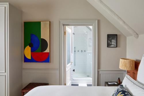 a bedroom with a bed and a bathroom with a shower at Erinvale Estate Hotel & Spa in Somerset West