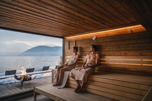 two women sitting in a sauna on a boat at Seehotel Das Traunsee in Traunkirchen