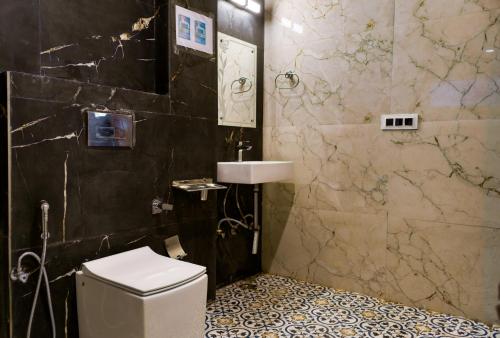 a bathroom with a toilet and a sink at The Frostwood Resort in Rānīkhet